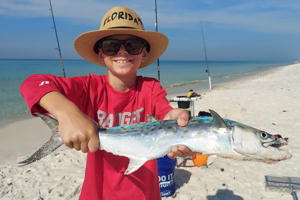 Young Boy Holding Spanish Mackerel Caught From The Surf